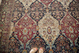 Top-down perspective of the multi-paneled floral design on a collector's antique Lavar Kerman carpet.