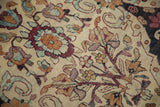 Detailed view of the low hand-knotted pile, showing germinating planter motifs and rare silk highlights.