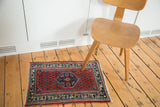 Vintage Engelas rug's red field, serrated medallion, and rich jewel-tone colors.