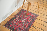 Hand-knotted Vintage Lilihan rug: cherry red floral bouquet, full pile, and original selvage.