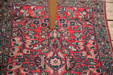 Close-up of Vintage Lilihan rug's cherry red field with navy and blush floral design.