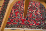 Hand-knotted vintage Lilihan rug with cherry red floral field and white fringe detail.
