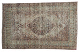 Antique Distressed Lavar Kerman rug, 1910s, dark floral medallion on a faded mil fleur field.