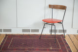 Bold vintage Belouch rug with brick red geometric floral field and localized wear.