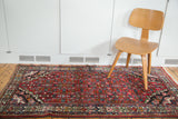 Vintage Borchalou rug's cherry red field with black corner spandrel and intricate herati design.
