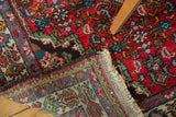 Vintage Borchalou rug's original fringe, plain weave foundation, and rich red herati design.