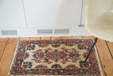 Vintage Persian Kerman rug: rococo floral bouquet, blush, navy, cochineal red on cream.