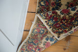 Hand-knotted vintage Kerman rug's folded corner; rococo floral pattern and secured edge.
