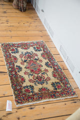 Vintage Kerman rug with rococo border of planters, floral arrangements, and secured fringe.