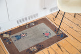 Art Deco Chinese rug brown border with blue, cream floral tendrils.
