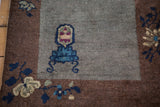Art Deco Chinese rug corner with grey field, bronze border, floral tendrils, and vase.