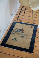 Secured fringe and dark cobalt border detail of an antique Peking rug.
