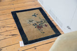 Secured fringe and dark indigo border of an antique Peking mat corner.