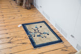 Antique Peking rug with blue floral and delicate tendril design on beige, indigo border.