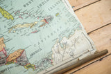 Antique map's bottom wooden dowel, with worn paper edge and South America detail.