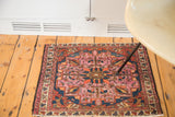 Antique Lilihan square rug mat showcasing softened raspberry, tangerine, and indigo motifs.