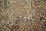 Distressed ram's horn motifs on antique Caucasian rug, showing woven reverse.