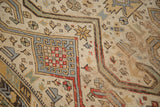 Distressed surface of antique Caucasian rug, highlighting geometric ram's horn and Perpedil motifs.