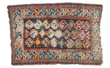 Antique Caucasian rug showcasing vibrant tangerine, indigo, aqua geometric gull motifs and distressed foundation, 3'5