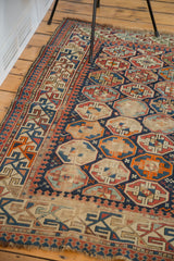 Distressed antique Caucasian rug with exposed foundation, energetic geometric arabesque borders.