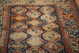 Antique Caucasian rug showing distressed geometric 'gull' motifs with exposed foundation.