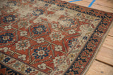 Antique distressed Caucasian rug with brick red floral field and contrasting Lotto inspired border.
