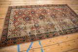 Antique Caucasian rug with distressed brick red field and unusual dark blue Lotto border.