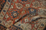 Distressed brick red field, splayed floral pattern, and unusual Lotto border.