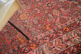 Vibrant distressed vintage Malayer runner detail, Herati design in red, orange, blue.