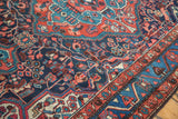 Detail of hand-knotted vintage Persian Dargazine rug with indigo, brick red, aqua motifs.