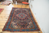 Aqua medallion section, brick red field, and detailed blue floral border of the Vintage Dargazine rug.