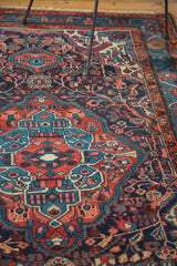 Aqua blue and brick red geometric floral motif on a vintage Dargazine rug.
