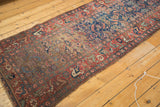 Striated gold abrash and madder red germinating seed border of the antique Kurdish Bidjar runner with even wear.