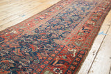 Madder root red border with playful motifs, indigo Herati field, and edge wear on antique Bidjar runner.