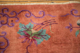Blush peach Art Deco rug, showing violet vines, mint green lily, and original side selvage.