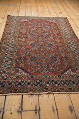 Antique Northwest Persian rug corner, distressed brick red field, indigo blue patterns, saffron border.