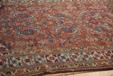 Antique Northwest Persian rug close-up: madder red field, indigo designs, saffron, and subtle patina.