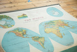 Angled view of the 1960's Rand McNally Merged Relief World Map with faded continents.