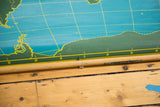 Bottom dowel of the vintage chalkboard world map with a visible crack near zero latitude.