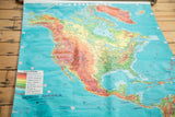 Mid-century pull-down map of North America with vibrant colors and visible crinkling.