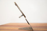 Side profile of the 1930s Hollywood mirror's chippy metal stand with patina.