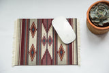Earthtone Southwestern mouse pad with geometric flatweave pattern in brick red, stone grey, and teal, 7x9 inches.