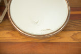 Vintage shaving mirror with rusted frame and visible crack on glass edge.
