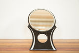Vintage Hollywood Mirror on black art deco metal stand with white accents.