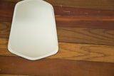 Lower right edge of the small Art Deco beveled mirror with spotted discoloration.