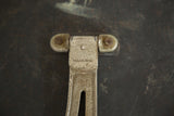 Ornate metal hinge detail of Victorian barber mirror, displaying PAT AUG. 26-02.