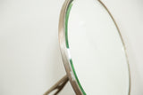 Patinated metal frame and beveled glass edge of the antique Victorian mirror.
