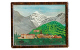 Antique folk art oil painting of a mountain village landscape in a dark wood frame.