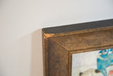 Corner of the miniature folk art painting's thick gold frame showing age.