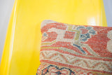 Hand-knotted texture of an antique Mahal pillow with coral, blue, and cream geometric design.